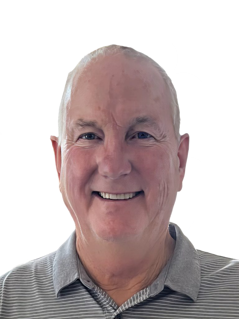 A smiling person with short hair is wearing a gray collared shirt against a plain background.