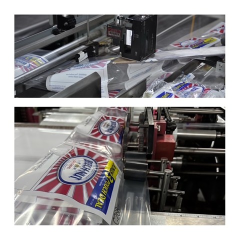 Bread loaves are being packed and sealed in a manufacturing facility.